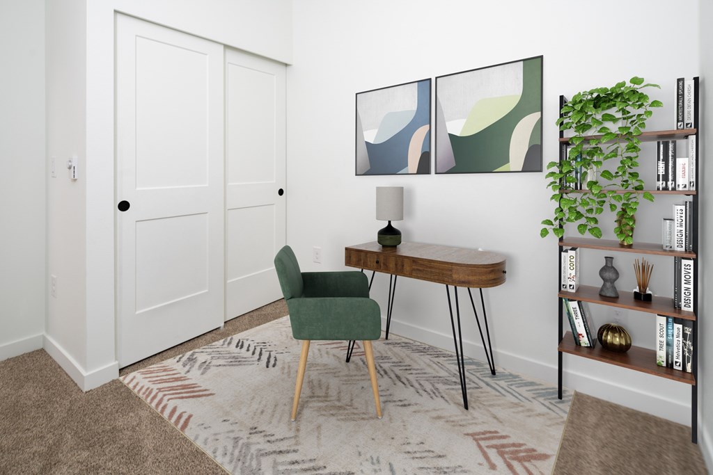A room with a green chair and a wooden table.