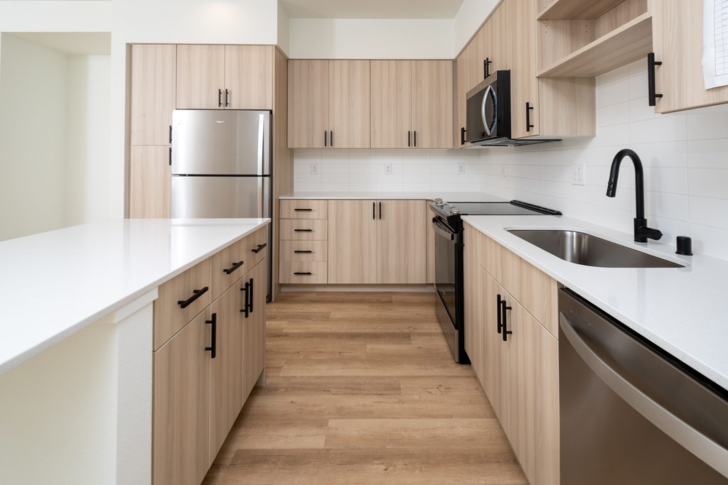 A kitchen with wooden cabinets and stainless steel appliances.