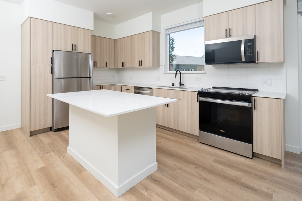 A kitchen with wooden cabinets and stainless steel appliances.