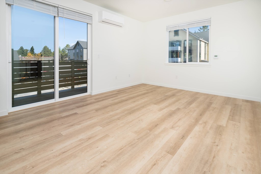 A room with a sliding glass door and a window.