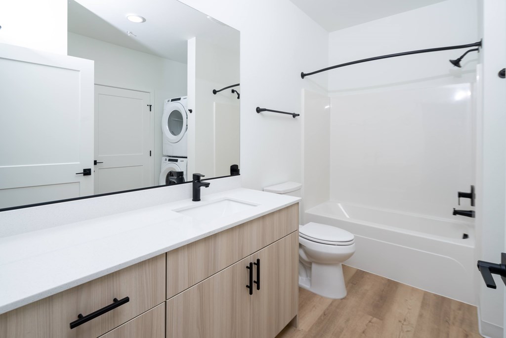 A white bathroom with a sink, toilet, and bathtub.