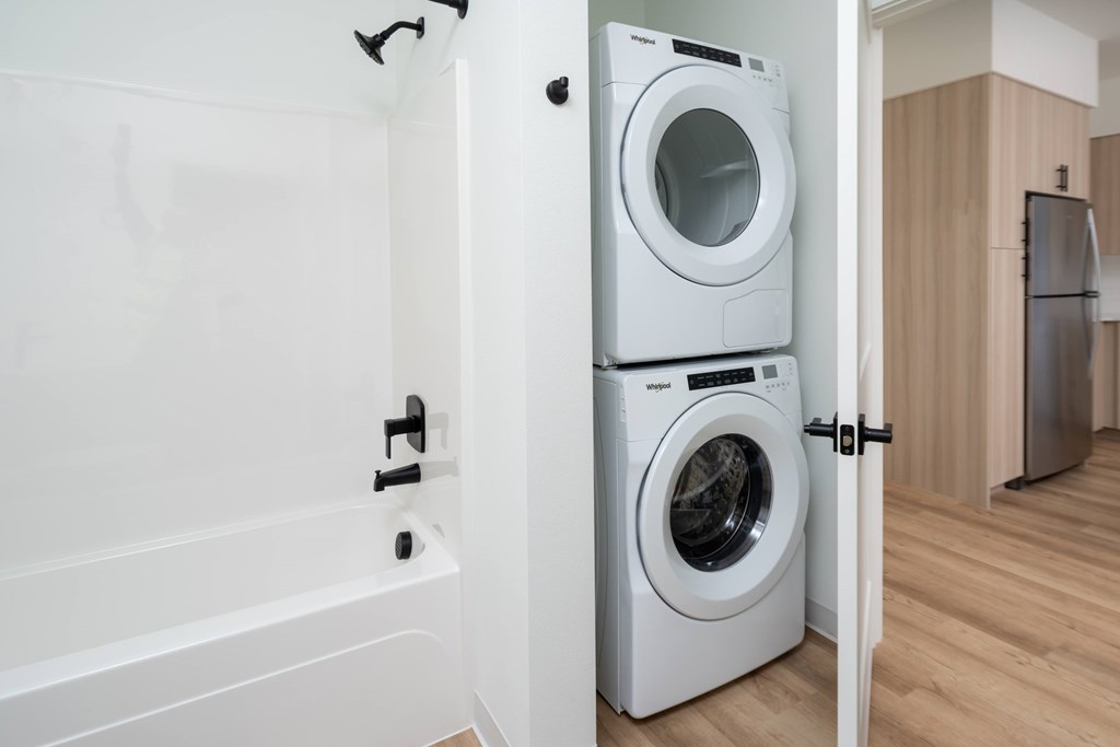 A white washing machine is in a doorway.