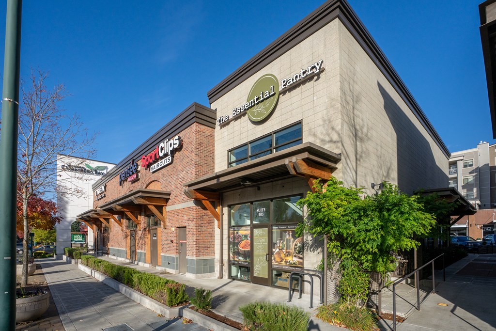 A Whole Foods Pantry store is located next to a 7-Eleven.