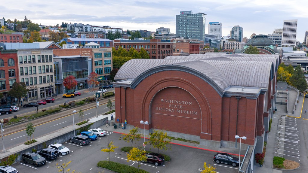 The Washington History Museum is a large red building with a curved roof.