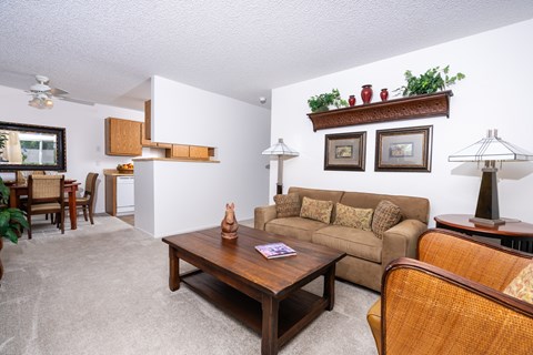 A living room with a couch, chair, and table.