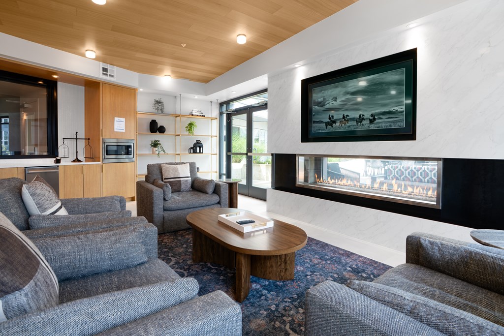 A living room with grey couches and a coffee table.