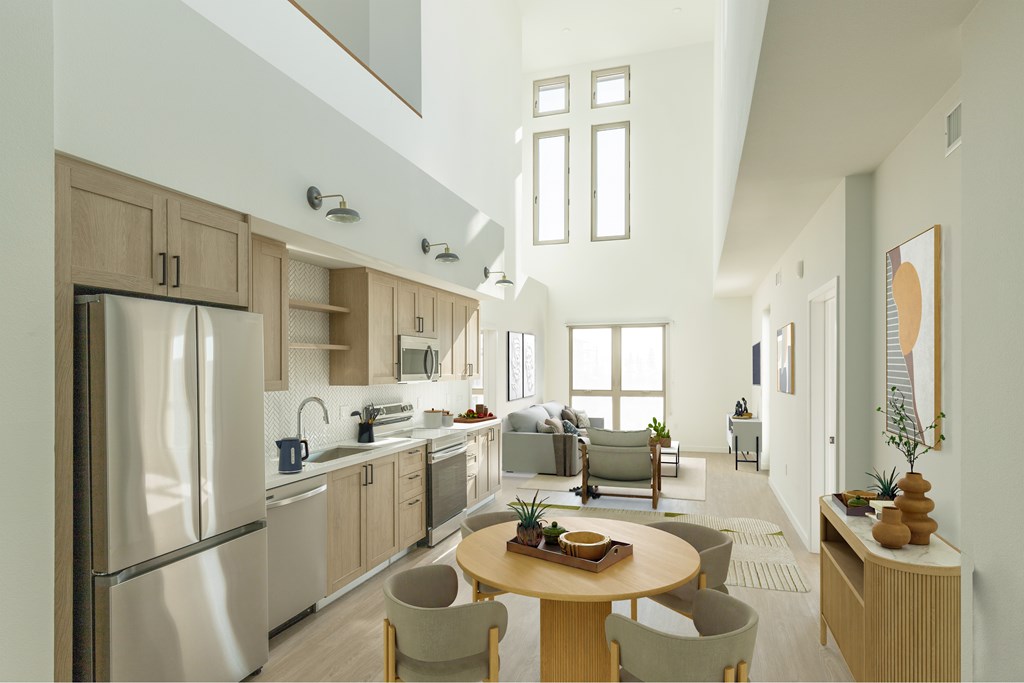 A modern kitchen with a dining table and chairs.