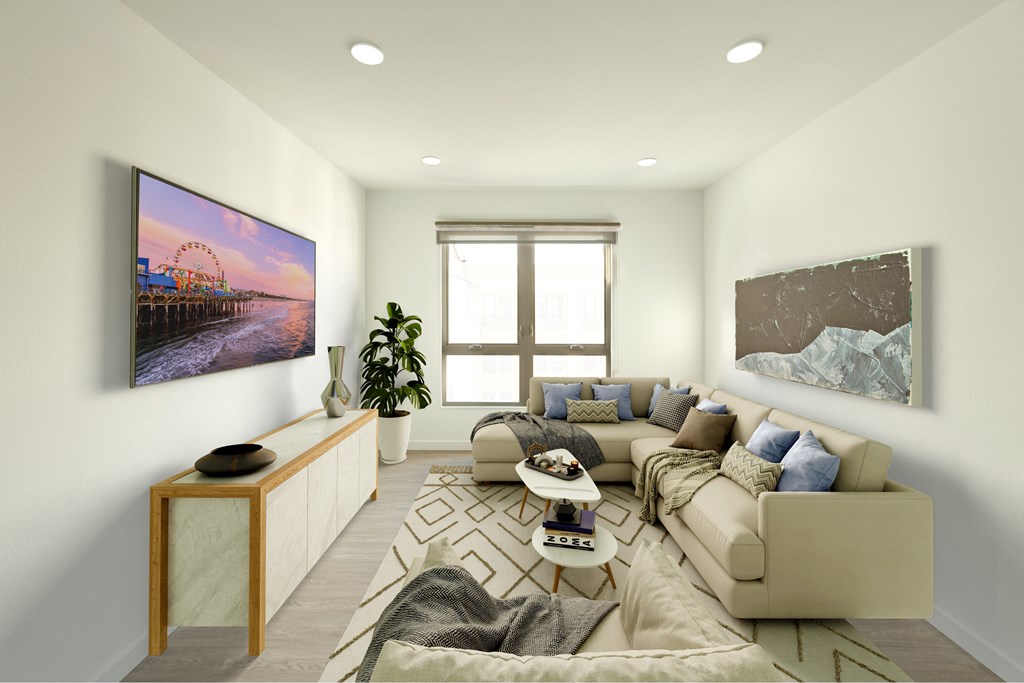 A living room with a large couch, a coffee table, and a painting on the wall.