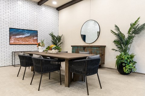 A dining room with a wooden table and chairs.