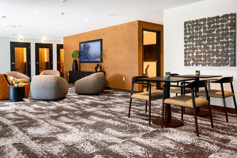 A living room with a brown carpet and a brown sofa.