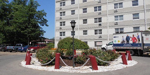 a roundabout with red and white barriers in front of a building