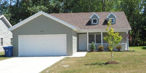 a white garage door in front of a house