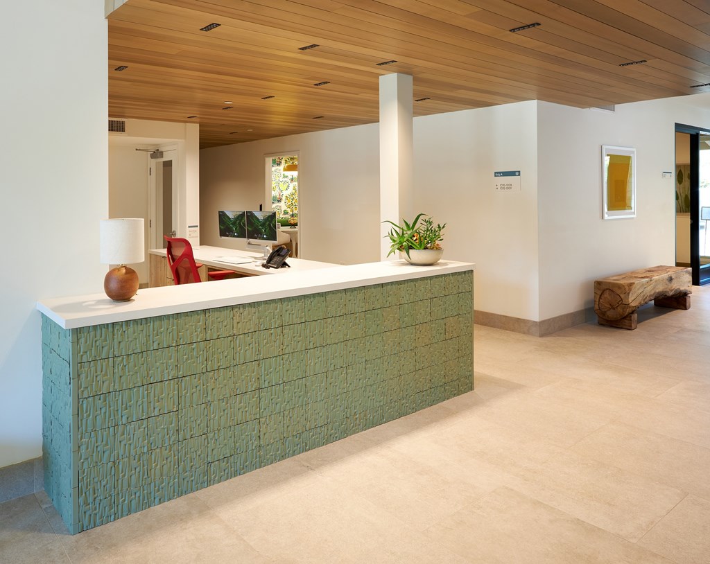 A reception desk with a green tile pattern.