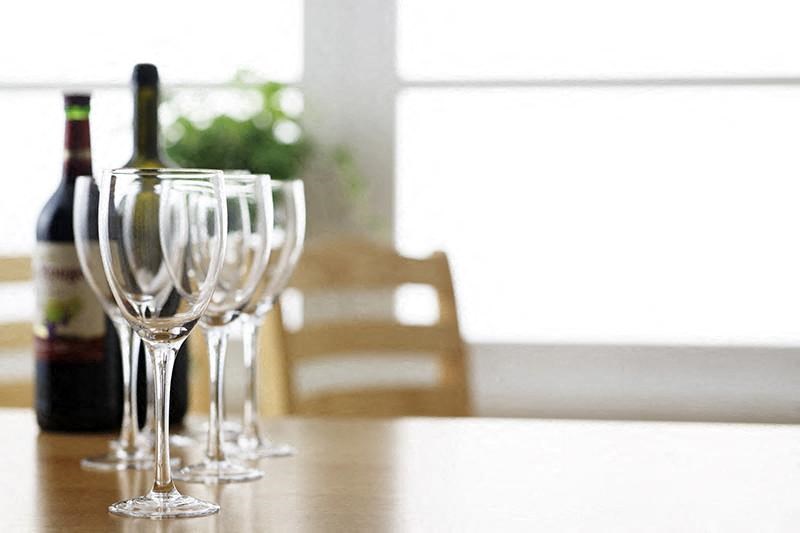 a table with wine glasses and a bottle of wine