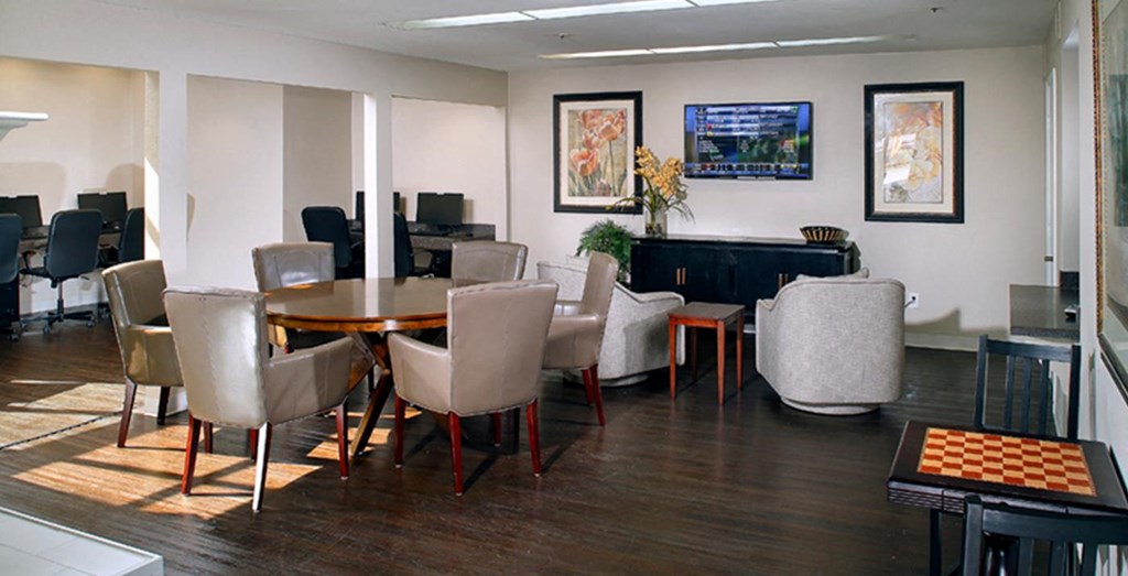 a conference room with a table and chairs and a piano