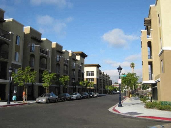 a city street with cars parked in front of buildings