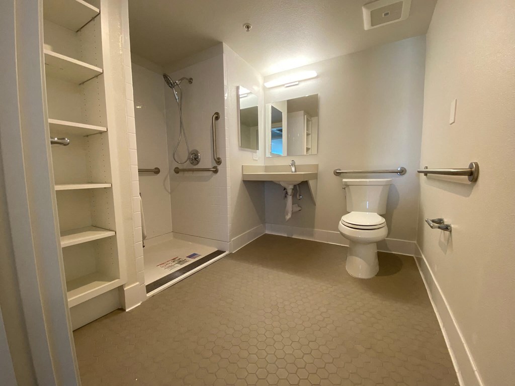 a bathroom with a toilet and a sink and a shower