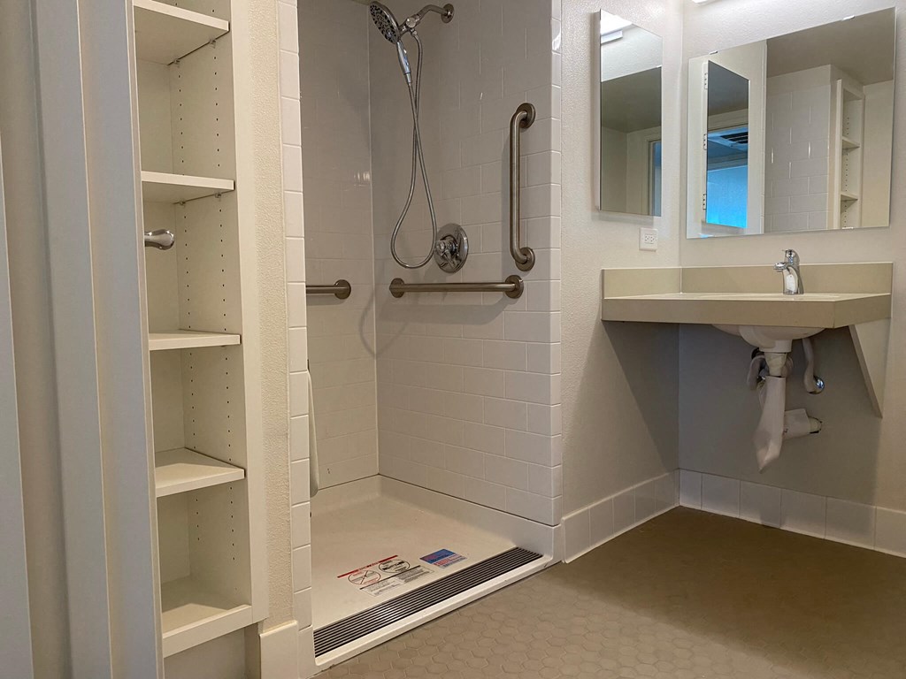 a bathroom with a shower and a sink in it