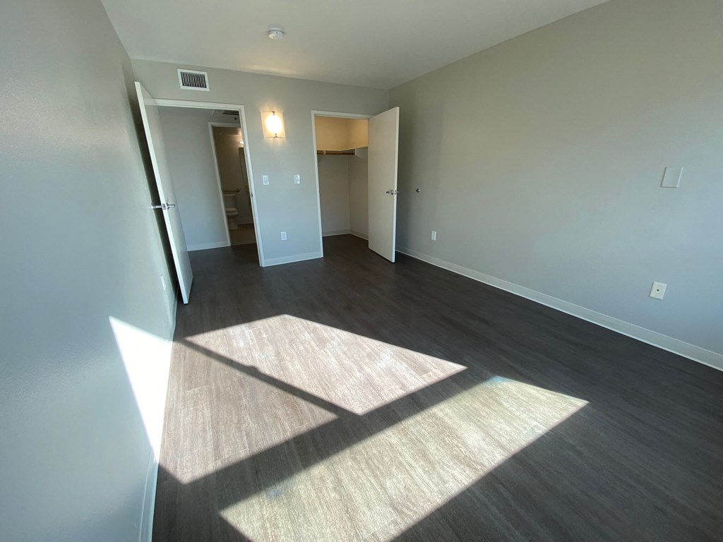 a view of a living room with wood flooring and a window