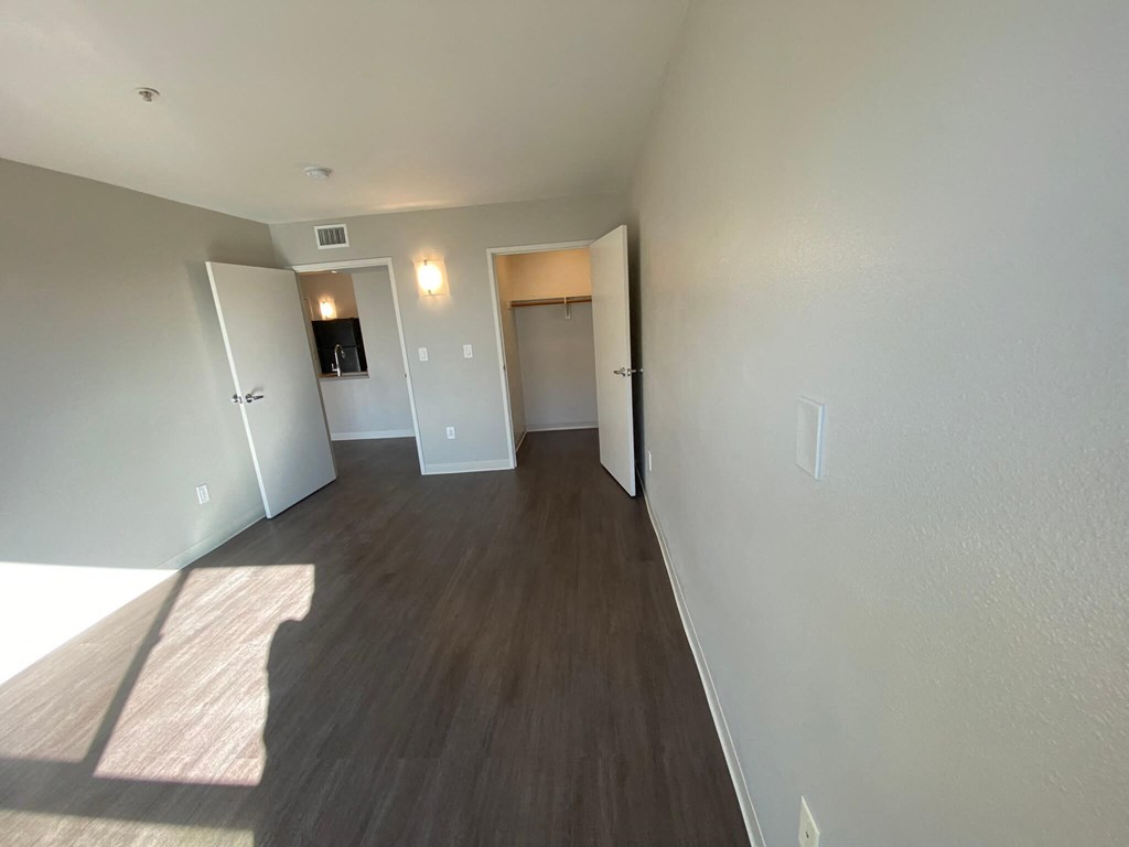 a view of a living room and hallway with wood flooring