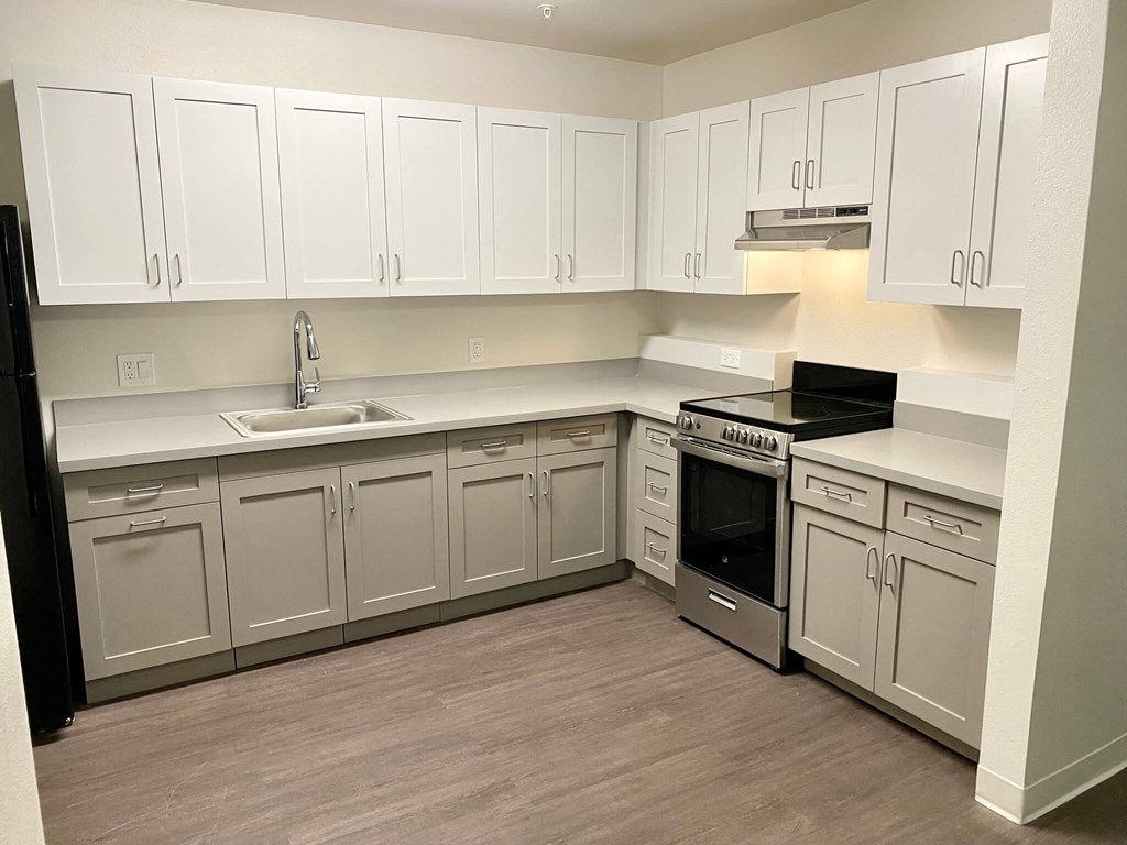 a kitchen with white cabinets and stainless steel appliances