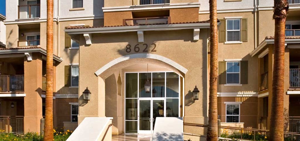an apartment building with a door and the address of 6832
