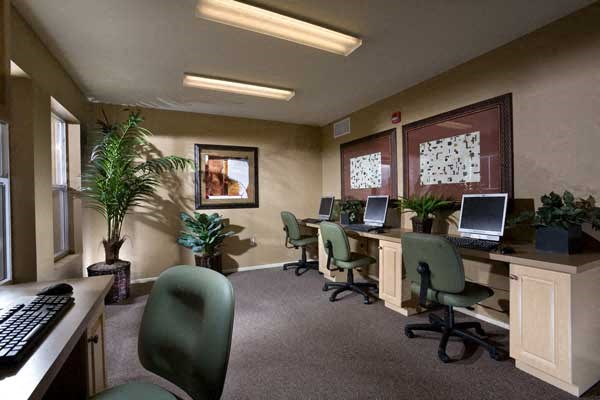 a room with computers and chairs and a keyboard