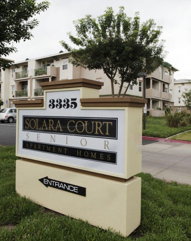 a solar court sign in front of an apartment building