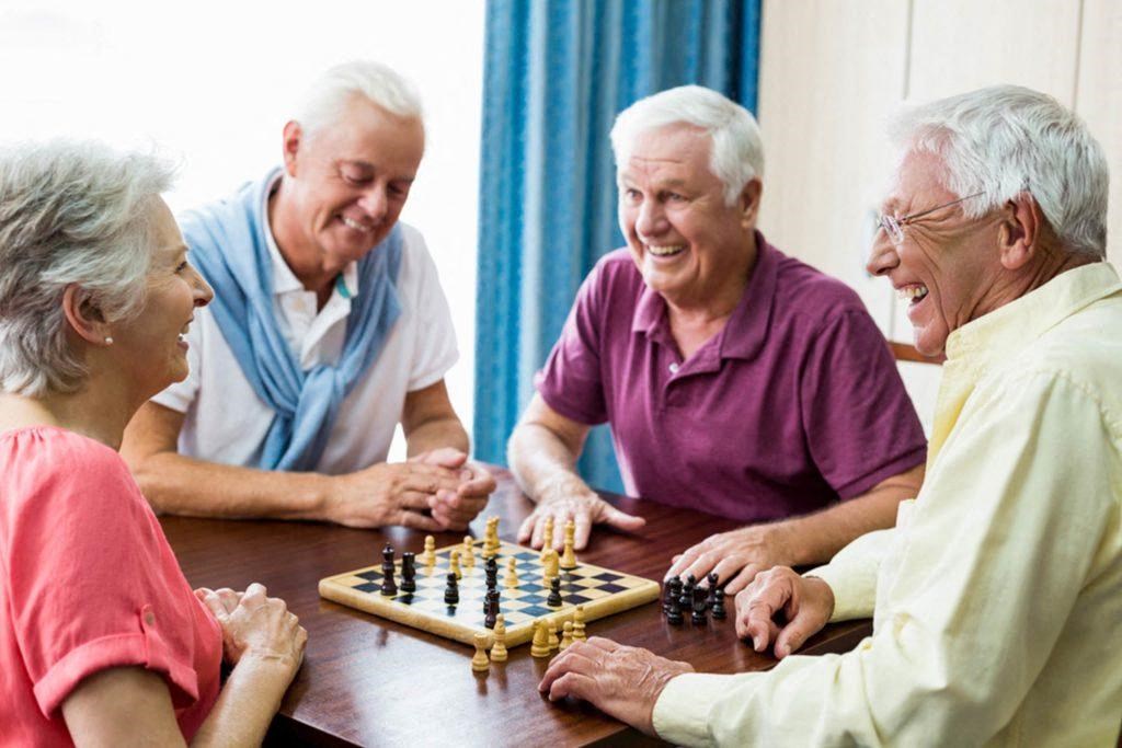 a group of seniors playing chess on a table