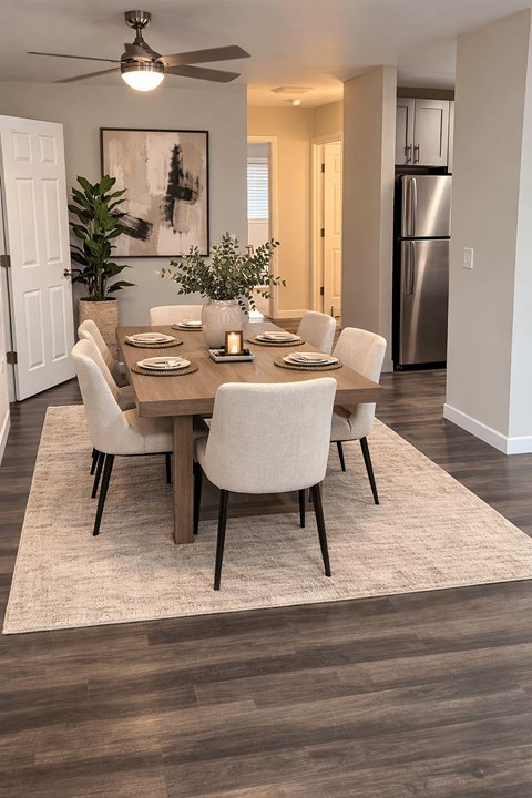 A dining room with a table set for six.