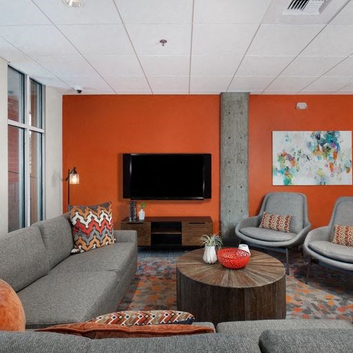 a living room filled with furniture and a flat screen tv