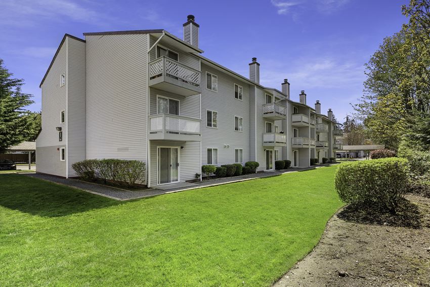 Exterior View of Apartments with Green Grassy Area Exterior View of Apartments with Green Grassy Area at Campo Basso Apartment Homes, Lynnwood