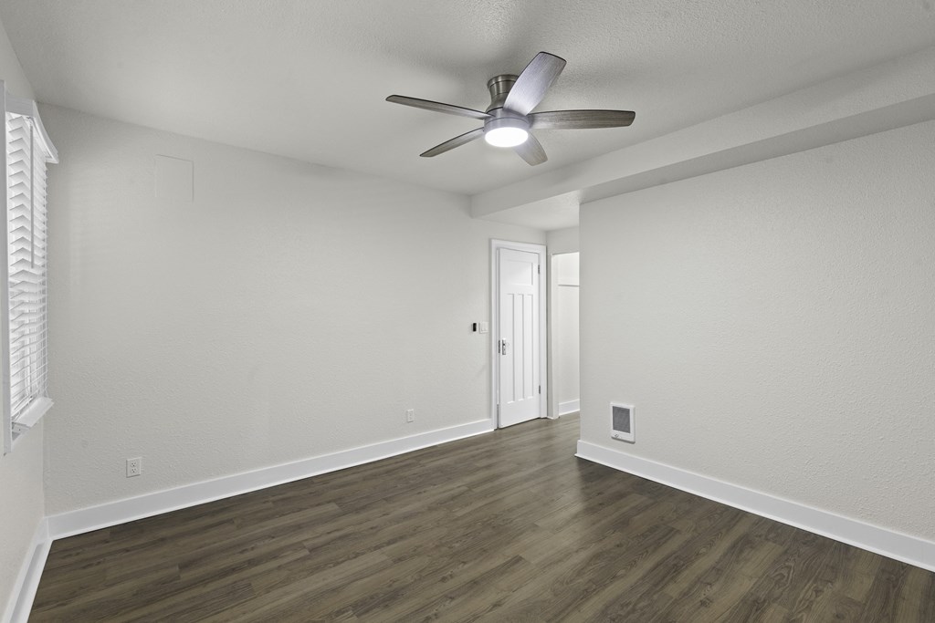 Living Area with Hardwood Flooring, Window with Blinds, and White Walls at Carolina Court Apartment Homes, WA 98109