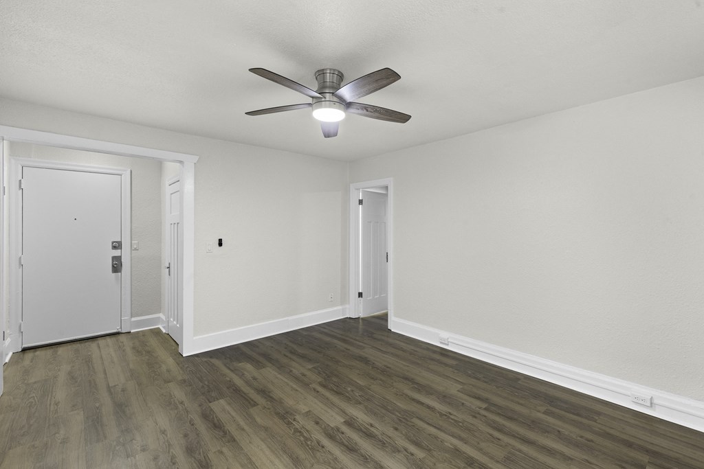 Living Space with Hardwood Floors, White Walls,  and an Overhead Ceiling Fan at Carolina Court Apartment Homes, Seattle, WA