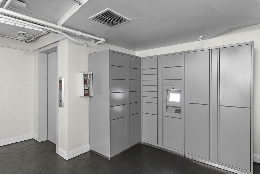 A Row of Gray Package Receiving Lockers in the Parcel Room with a White Walls at Carolina Court Apartment Homes, Washington