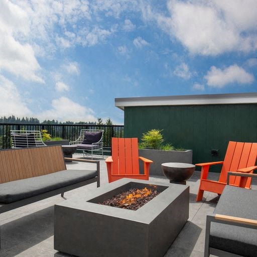 a patio with chairs and a fire pit