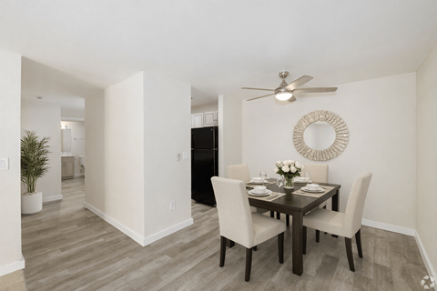 A dining room with a table set for four.