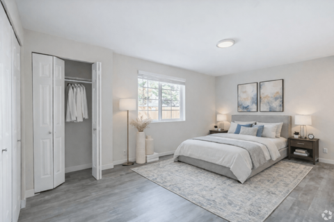 A bedroom with a large bed and a window.