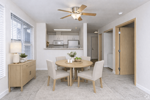 A dining room with a round table and chairs.