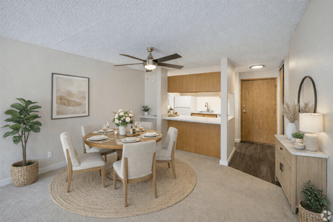 A dining room with a round table and chairs.