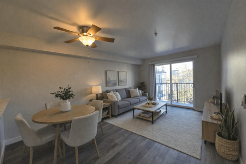 A living room with a dining table and chairs.