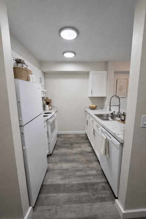A kitchen with white appliances and a white refrigerator.