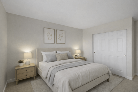 A bedroom with a bed, nightstand, and two wall lamps.