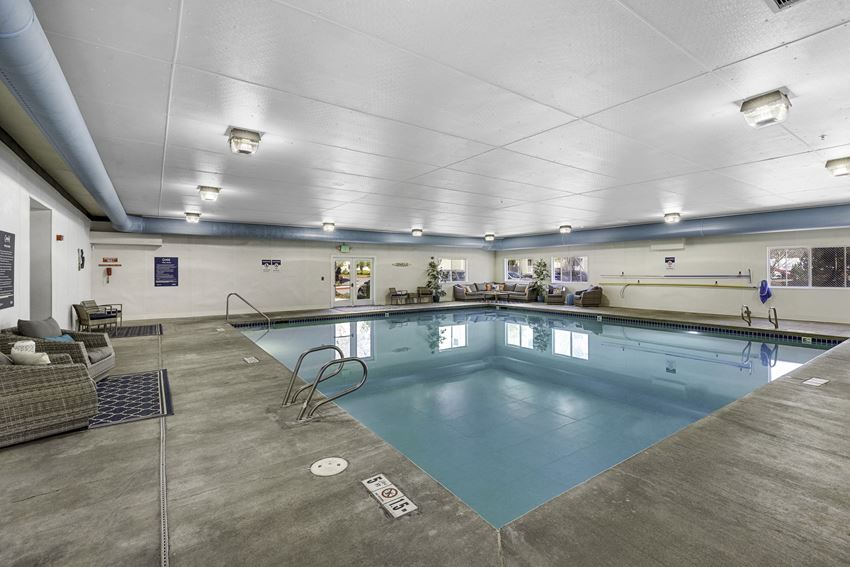 a large indoor swimming pool with a diving board a large indoor swimming pool with a diving board at Camelot Apartment Homes, Washington - Photo Gallery
