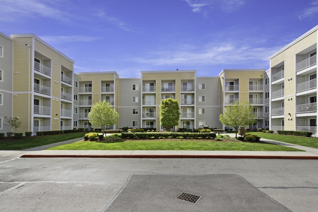 a picture of an apartment complex with a blue sky in the background  at Camelot Apartment Homes, Washington, 98204