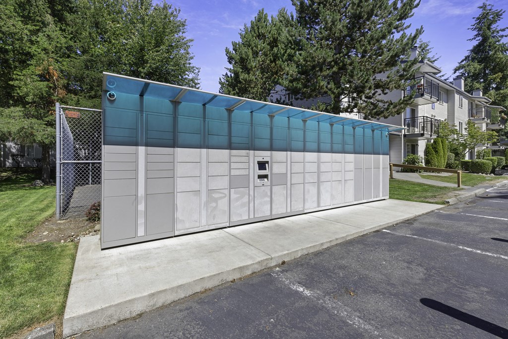 outdoor package locker station with trees in the background at Casa Blanca Apartment Homes, Everett