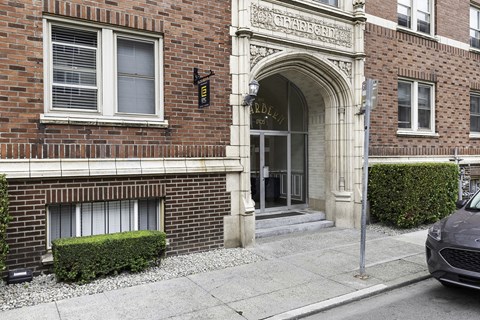 an antique-style building with a door and a car parked in front of it  at Charbern Apartment Homes, Seattle, Washington