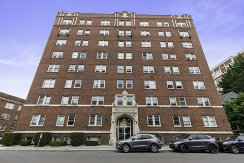 A large red brick building with a white door and windows.
