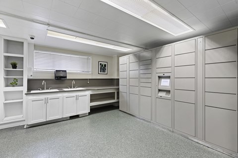 A clean, white-walled office kitchen with a counter and cabinets.