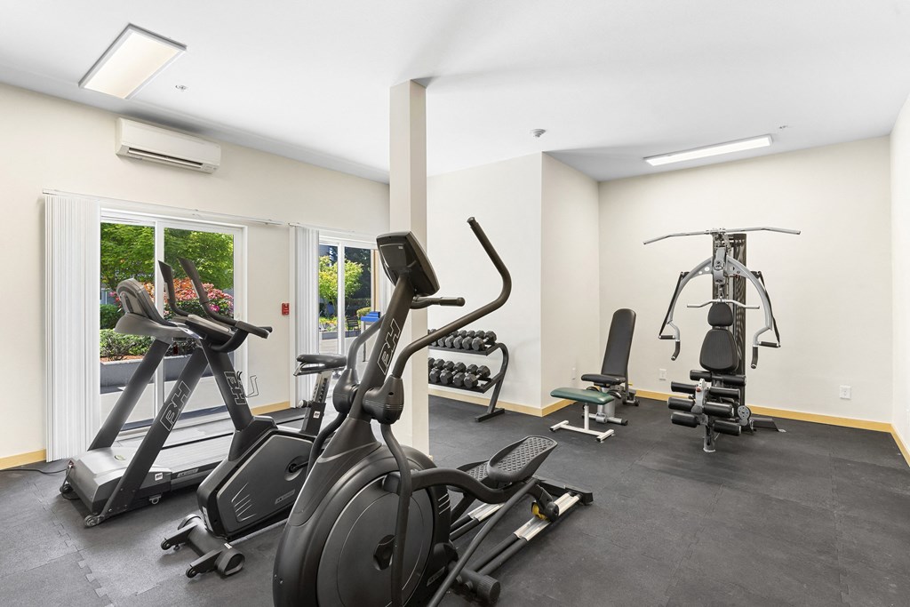 a gym with cardio equipment and weights at Guinevere Apartment Homes, WA 98103